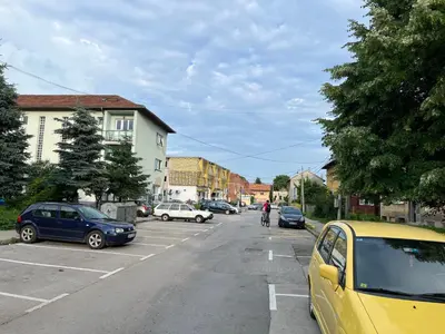 a street with cars parked in a parking lot at Stan na dan, Pazar Tuzla - centar grada in Tuzla
