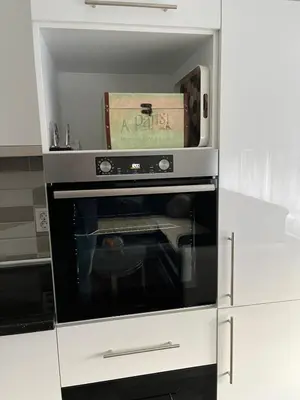 a microwave oven with a box on top of it at Stan na dan, Pazar Tuzla - centar grada in Tuzla