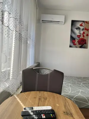 a room with a table with two remote controls on it at Stan na dan, Pazar Tuzla - centar grada in Tuzla