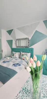 a bedroom with a bed and a vase of flowers at Apartman Kan in Bihać