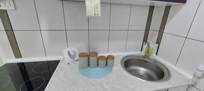 a small bathroom with a sink with woodenools next to it at Apartman Kan in Bihać