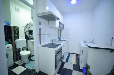 a small bathroom with a sink and a toilet at Apartman Kan in Bihać