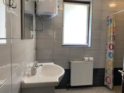 a bathroom with a sink and a window at Sunshine Apartments Visoko in Visoko