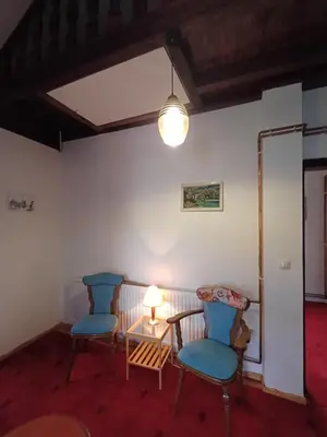 a room with two chairs and a table and a lamp at Sunshine Apartments Visoko in Visoko