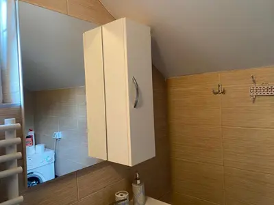 a bathroom with a white cabinet on the wall at Sunshine Apartments Visoko in Visoko