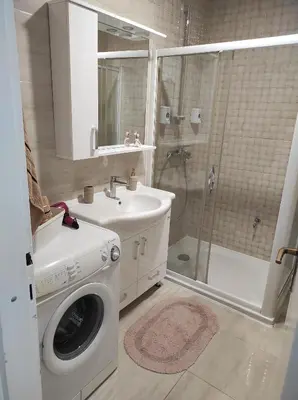 a bathroom with a washing machine and a sink at Perfect Place in Visoko