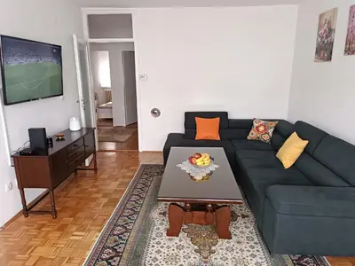 a living room with a blue couch and a table at Perfect Place in Visoko