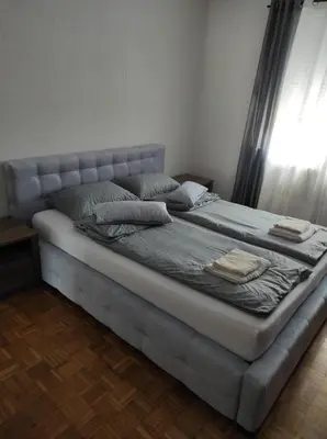 a large bed in a room with a window at Perfect Place in Visoko