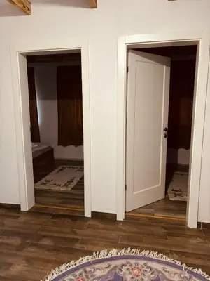 a room with two doors and a rug on the floor at Pool & Rest Holiday Home 3D in Bihać