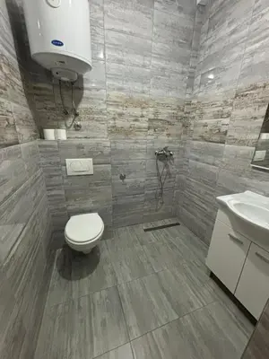 a bathroom with a toilet and a sink at Pool & Rest Holiday Home 3D in Bihać