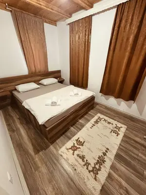 a bedroom with a large bed and a rug at Pool & Rest Holiday Home 3D in Bihać