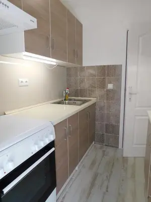 a kitchen with a sink and a stove at Tina apartman in Prnjavor