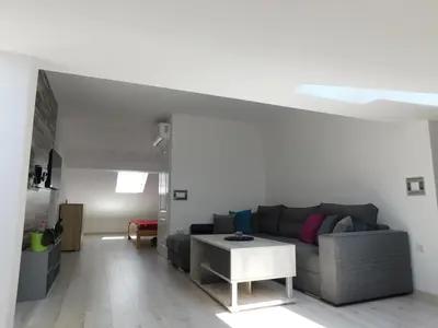 a living room with a couch and a table at Tina apartman in Prnjavor