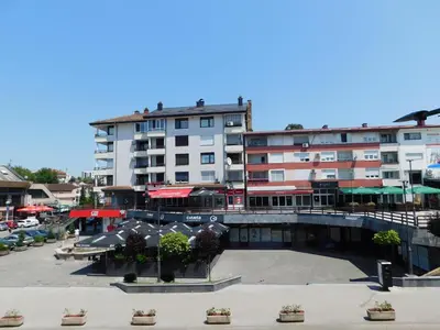 a large apartment building in a city with a courtyard at Tina apartman in Prnjavor