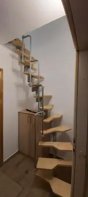 a staircase with wooden steps in a room at Tina apartman in Prnjavor