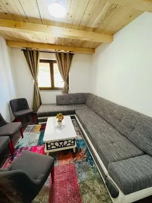 a living room with a couch and a table at Apartments & Homes with the river Una view in Bihać