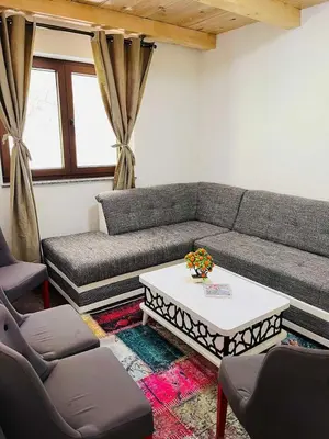 a living room with a couch and a coffee table at Apartments & Homes with the river Una view in Bihać