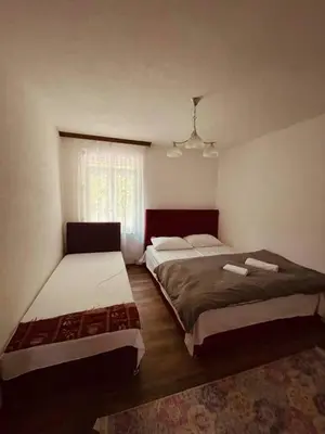 a bedroom with two beds and a window at Apartments & Homes with the river Una view in Bihać