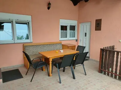 a wooden table and chairs in a room at Riverside Panorama Apartment 2 near City Center Brko 2 in Banja Luka