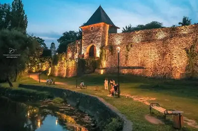 an old castle with people standing near a river at Riverside Panorama Apartment 2 near City Center Brko 2 in Banja Luka