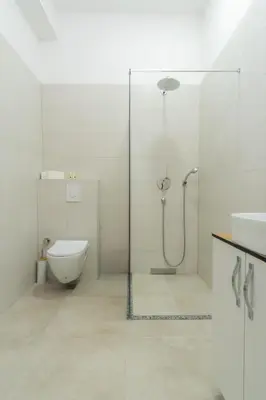 a bathroom with a shower and a toilet and a sink at Stan lux Kašmir in Bugojno
