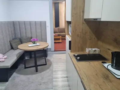 a kitchen with a small table in a kitchen at Stan lux Kašmir in Bugojno