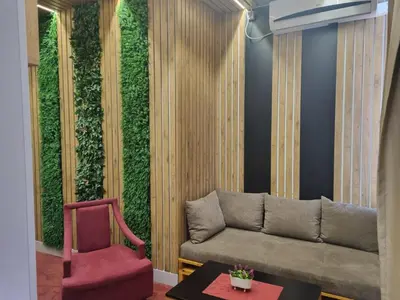 a living wall with a couch and a chair at Stan lux Kašmir in Bugojno