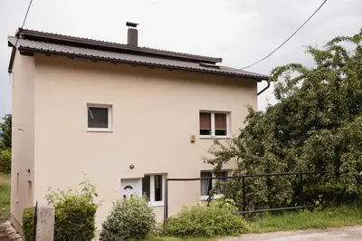 an image of a white house at Apartmani Romić R in Novi Travnik