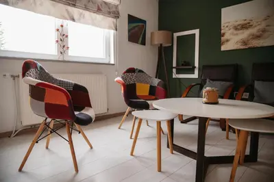 a living room with chairs and a table at Apartmani Romić R in Novi Travnik