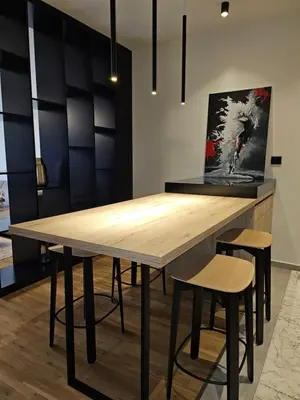a dining room with a wooden table and stools at ADAV Luxus Apartment in Visoko