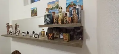 a shelf with vases and books on a wall at Vila Brdjanka in Šipovo