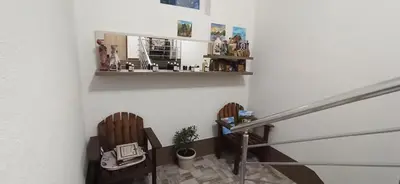 a staircase with two wooden chairs and a mirror at Vila Brdjanka in Šipovo