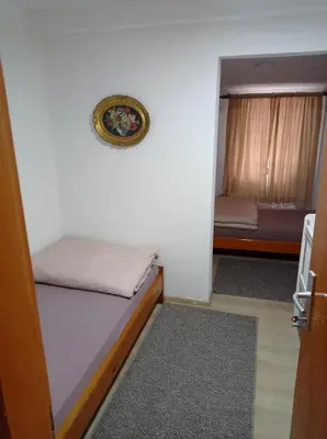 a small room with a bed and a mirror at Kuca za odmor Zlaja in Bihać