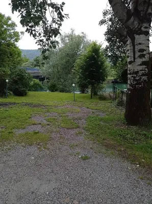 a gravel road next to a tree in a park at Kuca za odmor Zlaja in Bihać