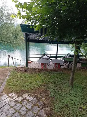 a picnic table with a view of the water at Kuca za odmor Zlaja in Bihać