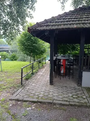 a pavilion with tables and chairs in a park at Kuca za odmor Zlaja in Bihać