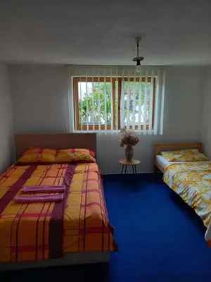 a bedroom with two beds and a window at Guest House Visoko in Visoko