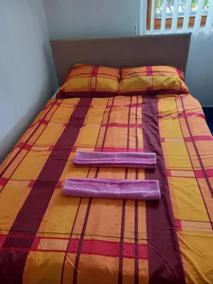 a bed with two pillows on top of it at Guest House Visoko in Visoko