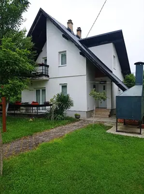 a white house with a black roof at Vila Zlaja in Bihać