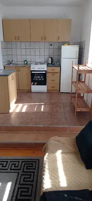 a kitchen with a stove and a refrigerator at Vila Zlaja in Bihać