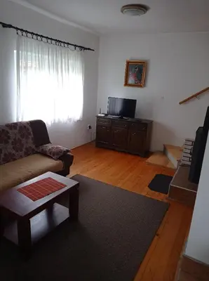 a living room with a couch and a flat screen tv at Vila Zlaja in Bihać