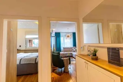 a bedroom with a bed and a living room at Platinum_Luxury_Apartment II in Teslić