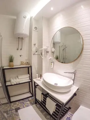 a white bathroom with a sink and a mirror at Platinum_Luxury_Apartment II in Teslić