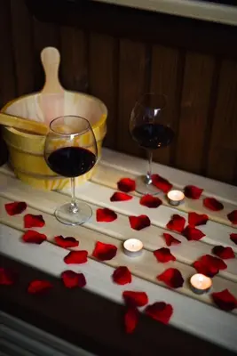 two glasses of wine and red hearts on a table at Platinum_Luxury_Apartment II in Teslić