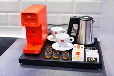 a counter with a coffee maker and cups on it at Platinum_Luxury_Apartment II in Teslić