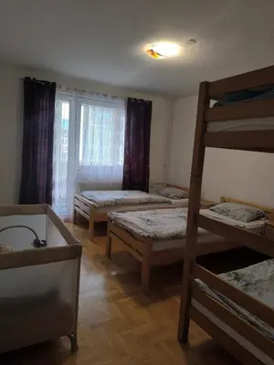 a room with three bunk beds and a ladder at Doboj Apartman in Doboj