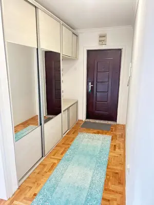 a hallway with a door and a mirror at Doboj Apartman in Doboj
