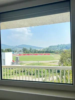 a window with a view of a field at Doboj Apartman in Doboj