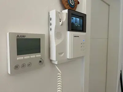 an acer computer and a monitor on a wall at Apartman My Choice in Bihać