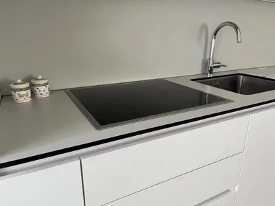 a kitchen sink with a stainless steel counter top at Apartman My Choice in Bihać